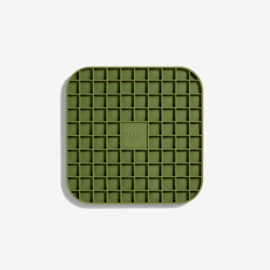 A khaki green coloured square lickimat with rounded edges and gridded squared inner pockets, on a white background.