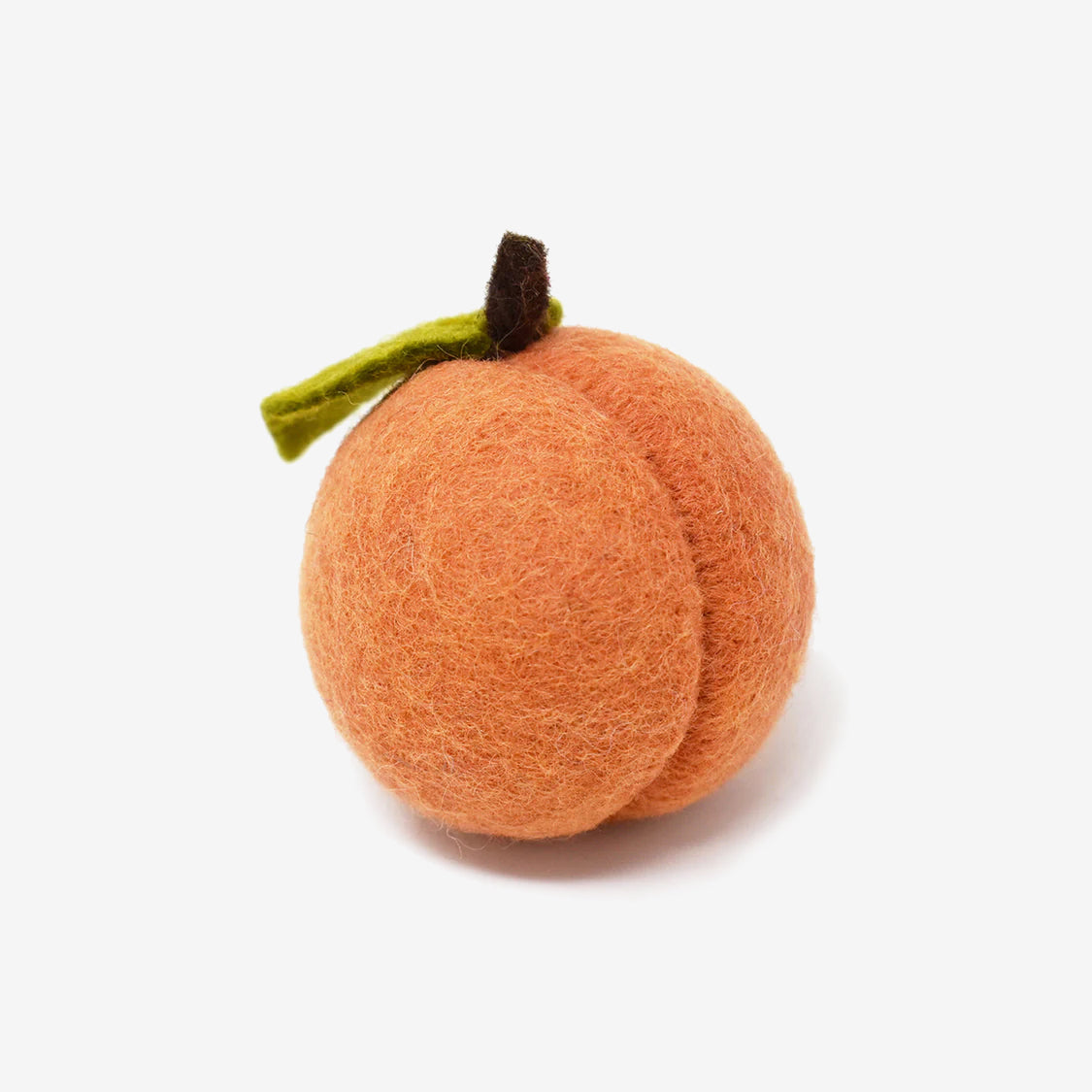 A felted wool peach toy with a green leaf on a white background.
