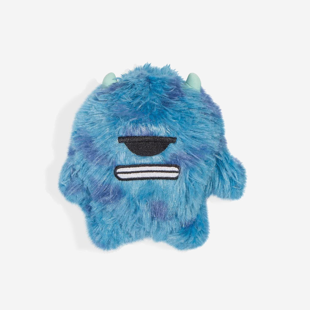 Fluffy blue monster plush dog toy with horns and a closed-mouth smile on a white background.