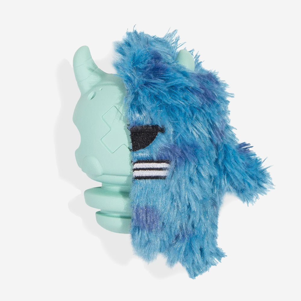 A turquoise and blue furry dog toy with an eye-patch and striped detail on a white background.
