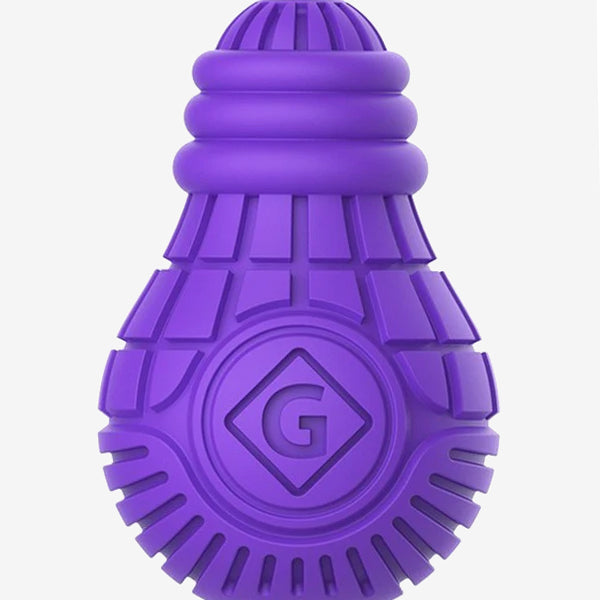 Purple bulb shaped dog toy with a hollow center to put treats inside with exterior grooves.