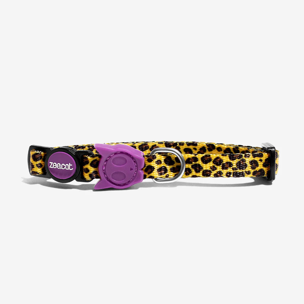 Leopard print cat collar with a purple adjustable buckle and a metal D-ring for attaching a leash or ID tag.