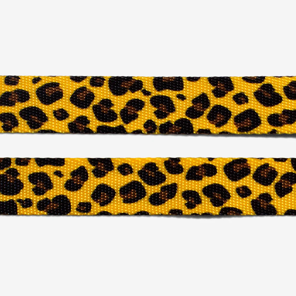 Two textured ribbons featuring a vibrant yellow background adorned with scattered black leopard spots.