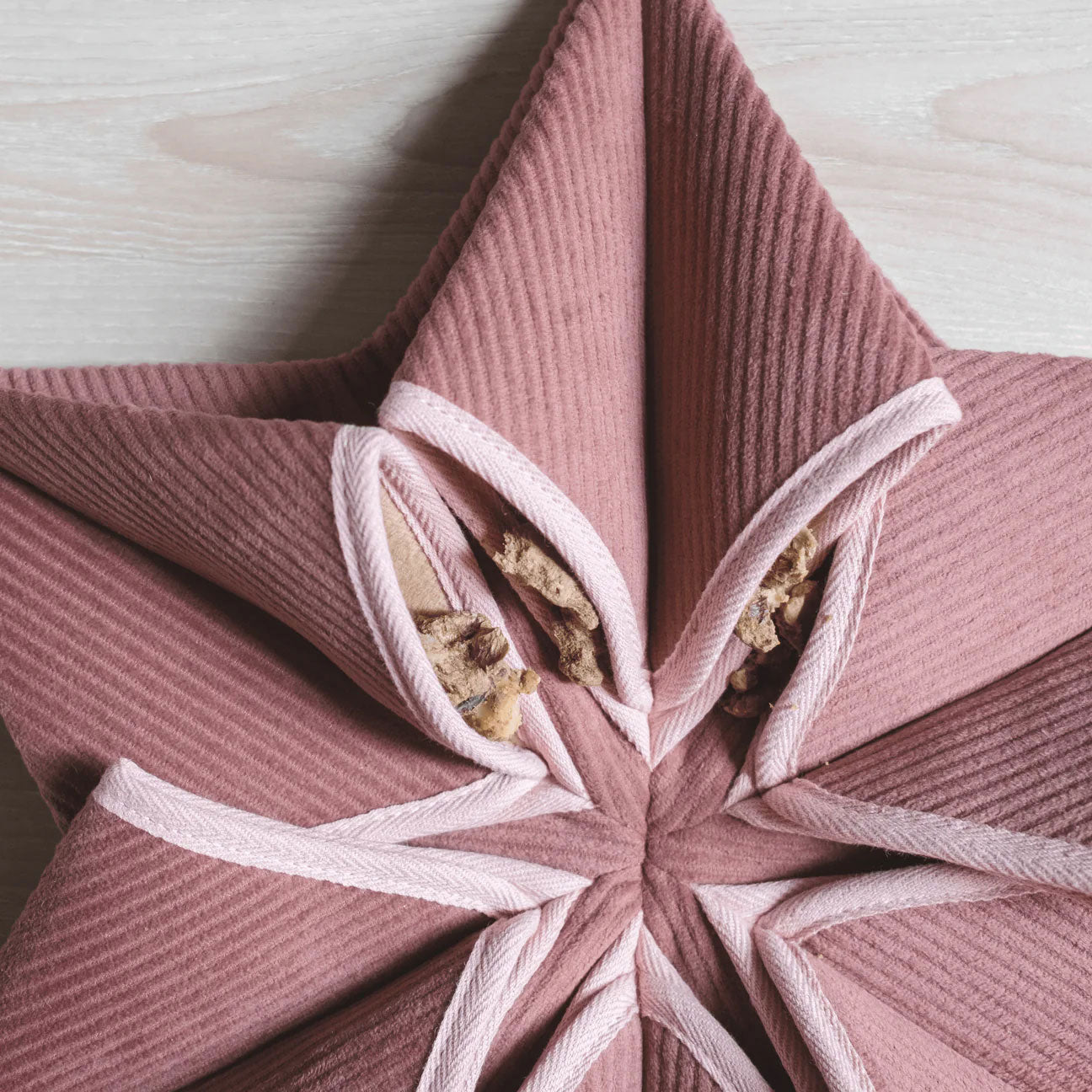 Close up of "Lambwolf Collective's" large snuffle matt, in rose pink, stuffed with dog treats.