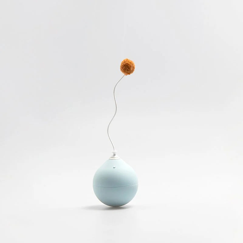 A blue spherical cat toy with a single pom pom on a stem curving out from the top on a white background.