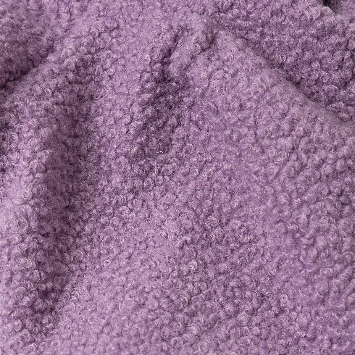 Close-up of a textured lilac fabric with a curly pile design.