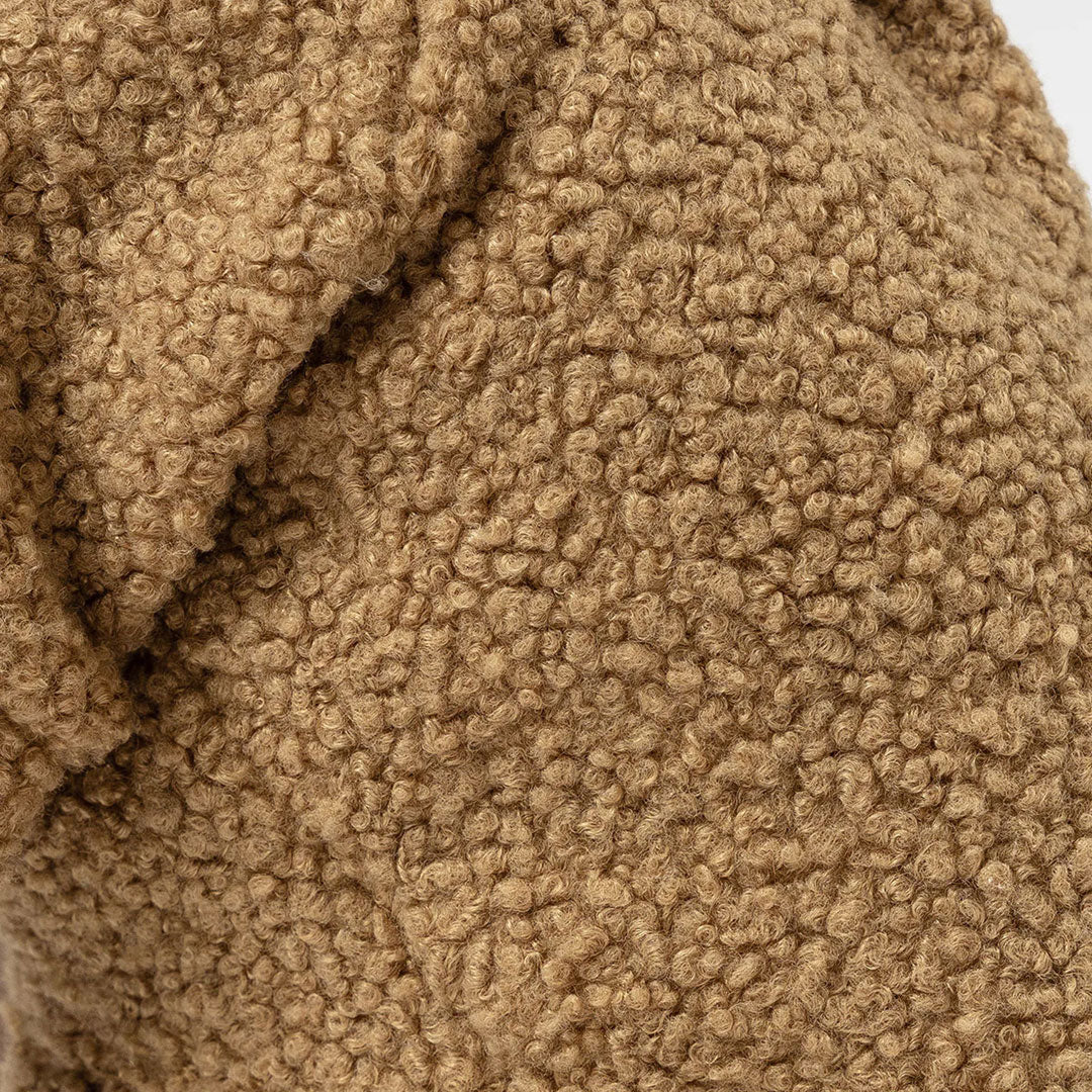 Close-up of a textured taupe fabric with a curly pile design.