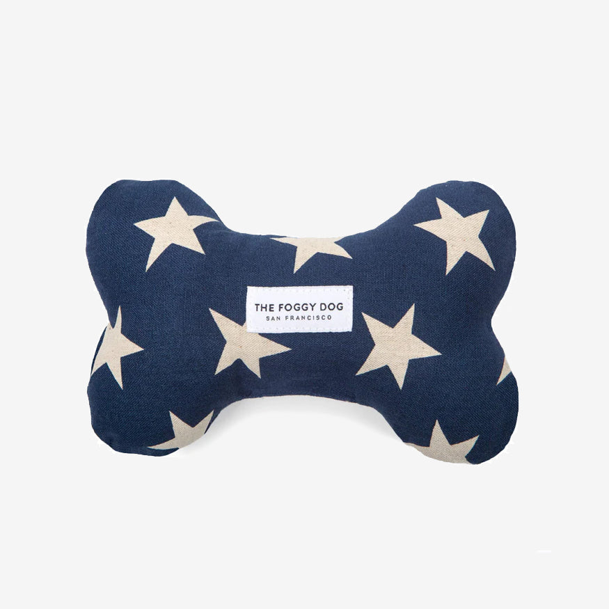 Bone-shaped dog toy with white stars on navy blue fabric, labeled "The Foggy Dog San Francisco."