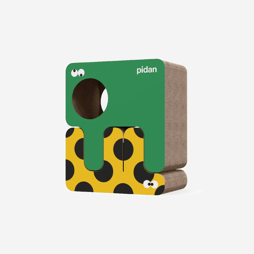A colourful cat scratcher with a cartoon-monster like design, featuring green, yellow with black dots, and brown textures.