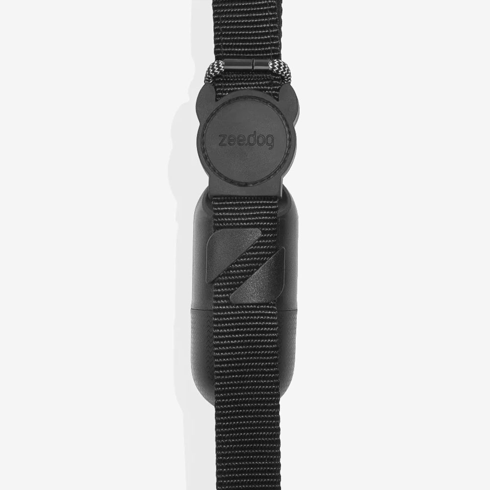 A close-up of a black dog leash with a circular Zee dog logo, highlighting the durable strap and clip design.