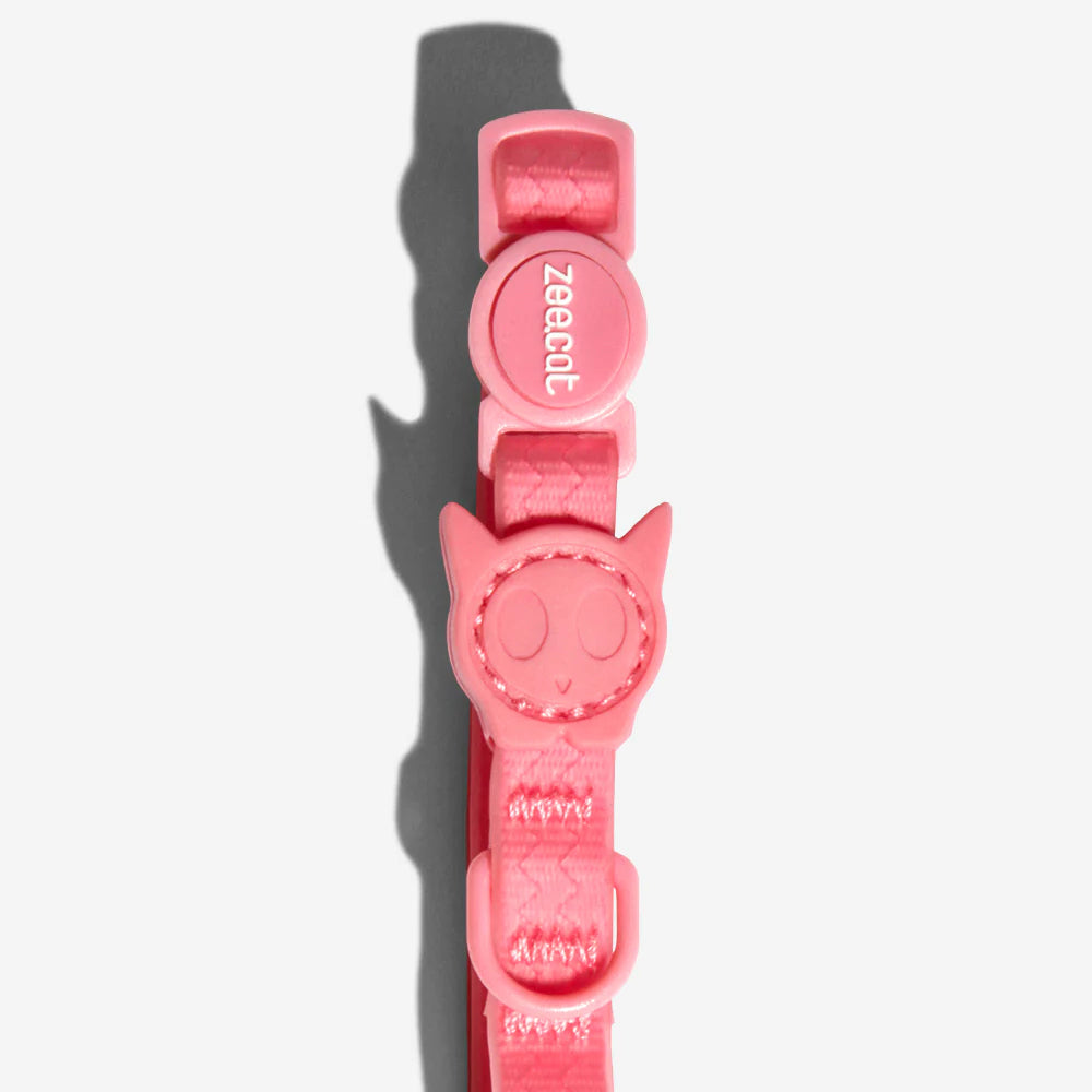 Pink cat collar featuring a playful cat face charm and a "zeecat" logo emblem, designed for pets.