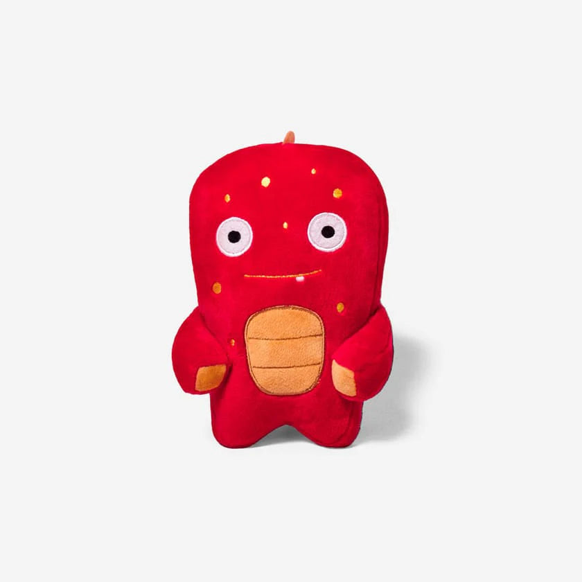 Red plush alien toy with cute eyes and a orange chest and spots on a white background.