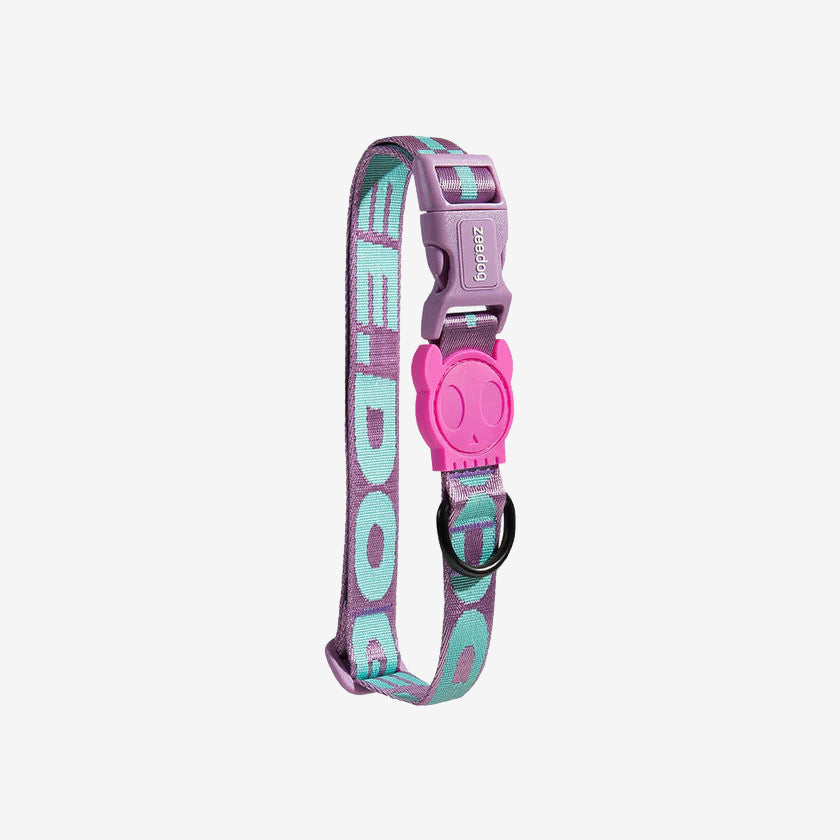Colourful pet collar with a purple and turquoise design, featuring a pink skull-shaped clasp and black metal ring.