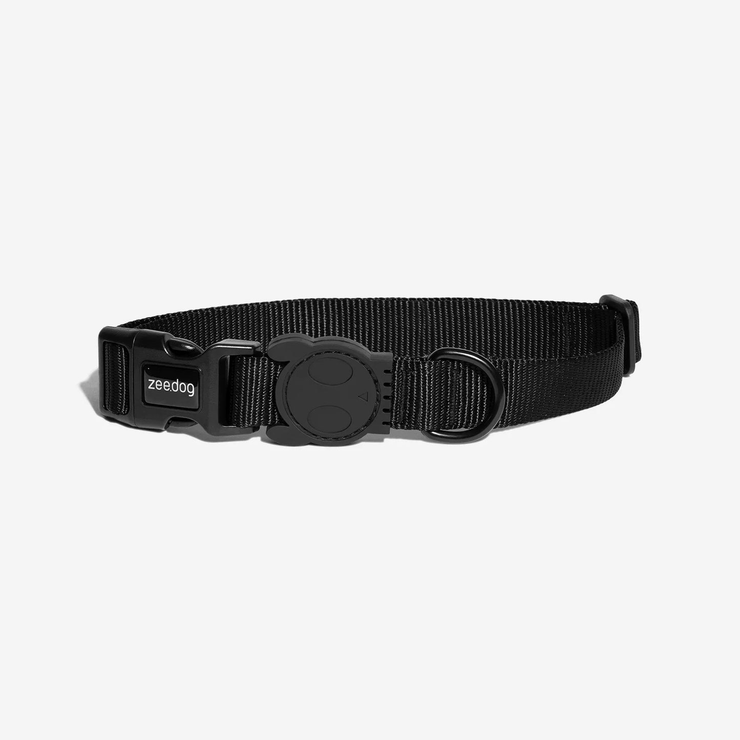 Black dog collar made of durable nylon, featuring a sleek buckle and a circular attachment ring, designed for comfort and style.