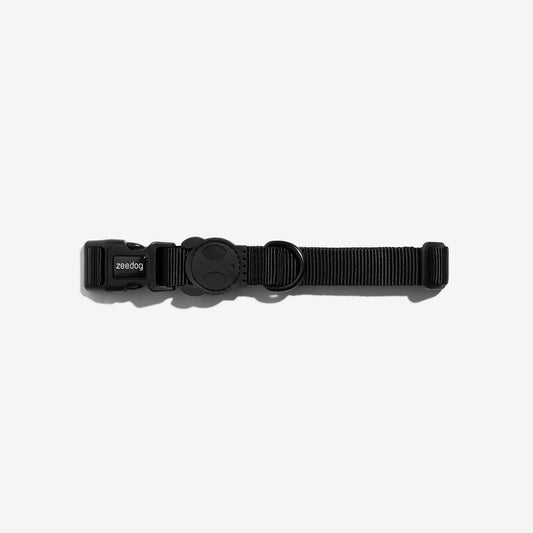 Black dog collar with a sleek buckle and a rounded D-ring, featuring the "zeedog" brand logo, set against a white background.