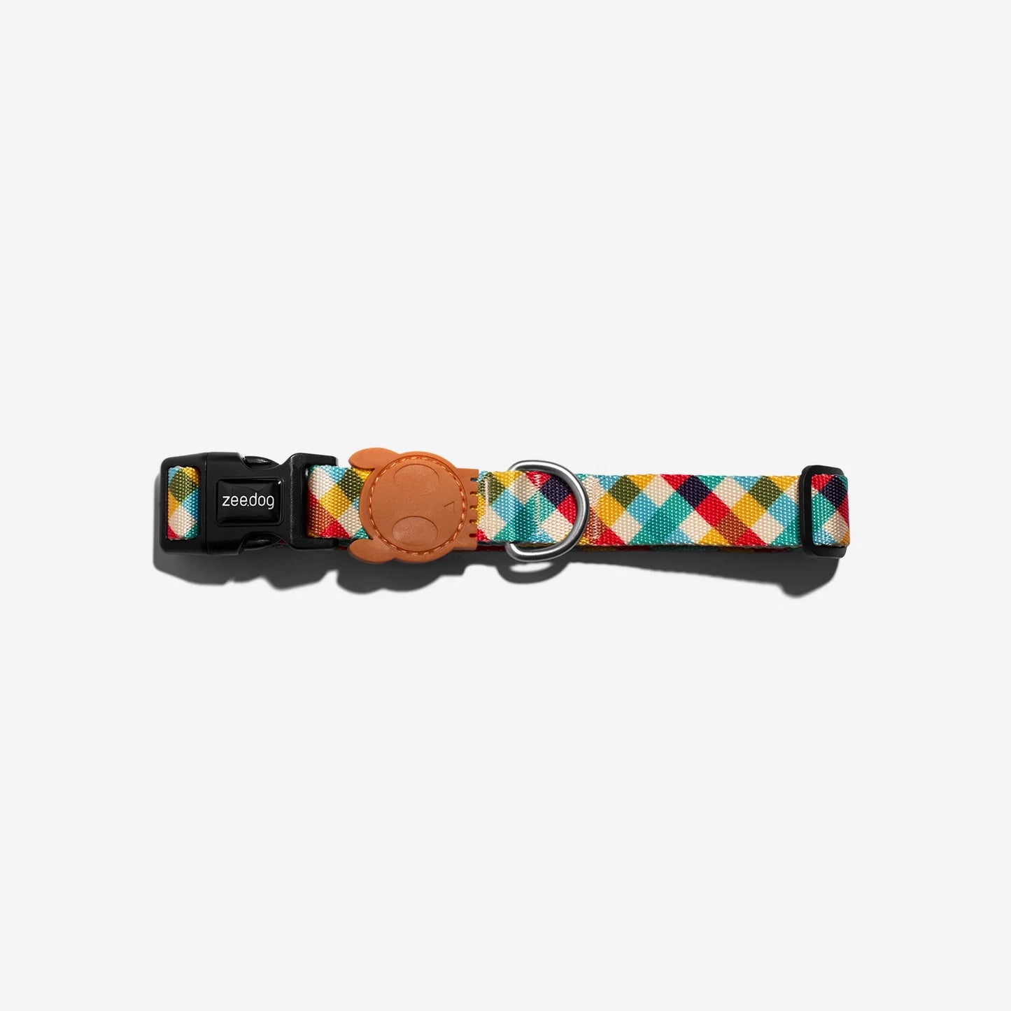 Colourful geometric-patterned dog collar with a black buckle and leather tag, featured against a white background.