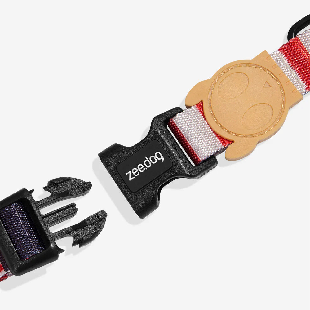 A colourful pet collar featuring a black buckle, a beige owl-shaped attachment, and the logo "zee.dog" prominently displayed.
