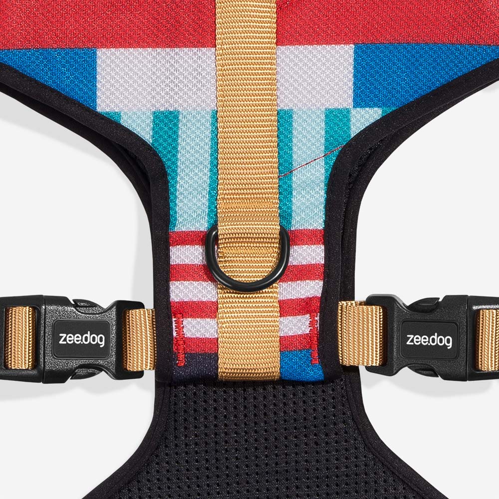 Colourful dog harness with a geometric pattern and branded buckles.