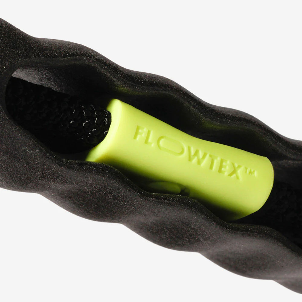 Close-up of a black and neon green "FLOWTEX™" branded object with a textured interior.