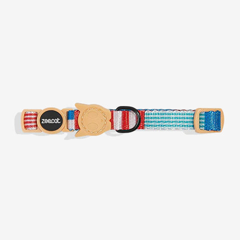 Colourful cat collar featuring red, blue, and white stripes with a leather tag displaying the brand "zee.cat."
