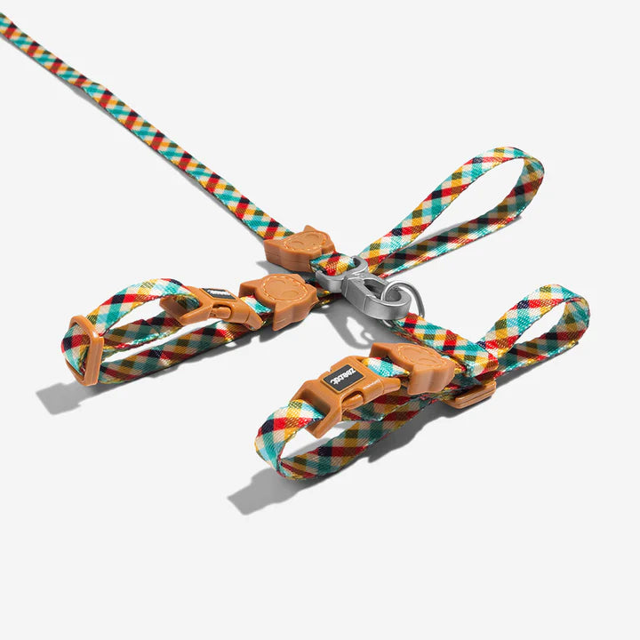 Colourful diamond patterned cat leash with brown clips and a aluminium hook, on a white background.