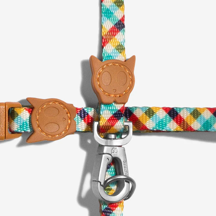 Close up of a colourful diamond-patterned and textured leash with a galvanised alumnium hook on a white background.