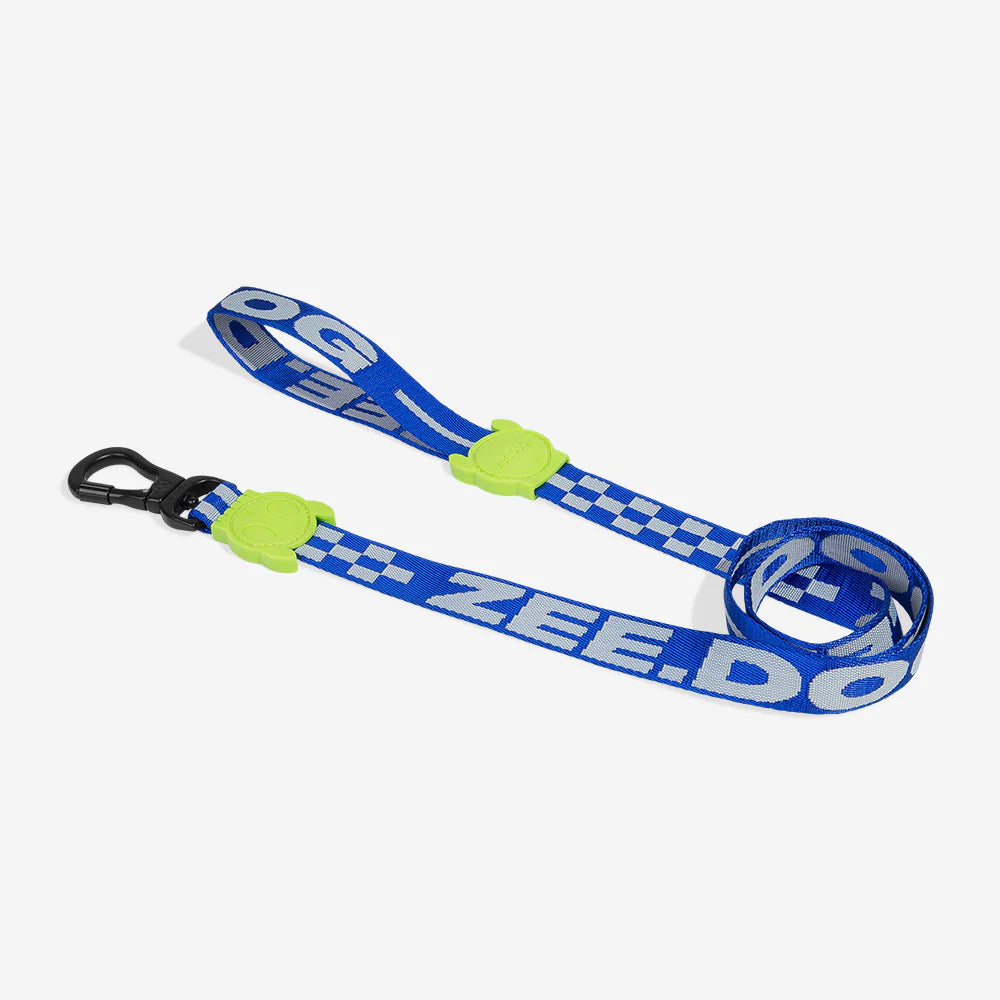 Blue and white checkered dog leash with two neon green rubber skull motif and a black hook.