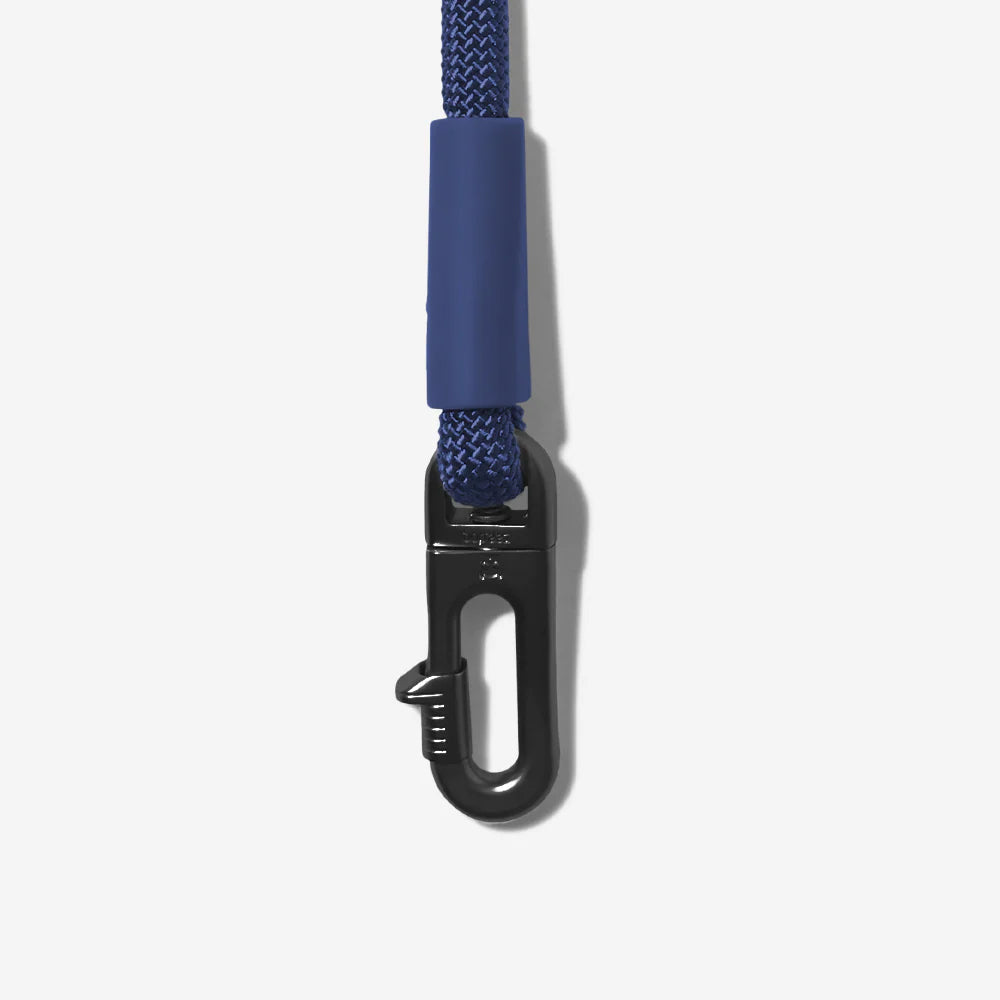 A close-up of a navy blue rope dog lead with a black metal carabiner clip attached at the end, showcasing its durable design.