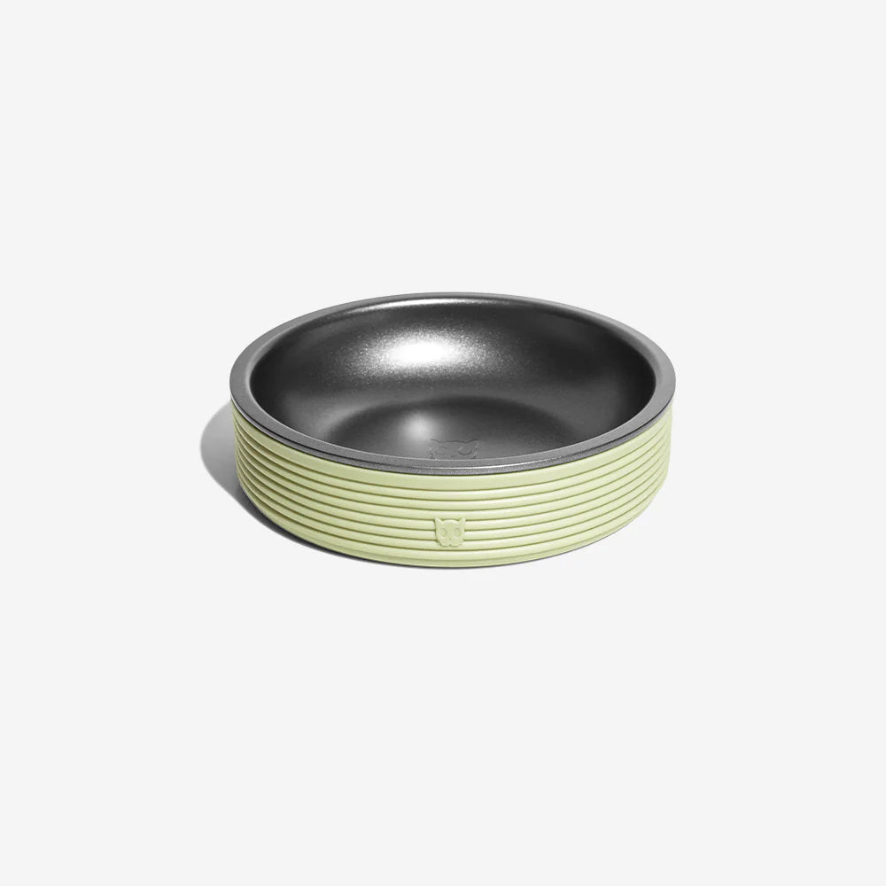 A stylish pet bowl featuring a textured lime green exterior and a sleek black interior. Ideal for food or water.