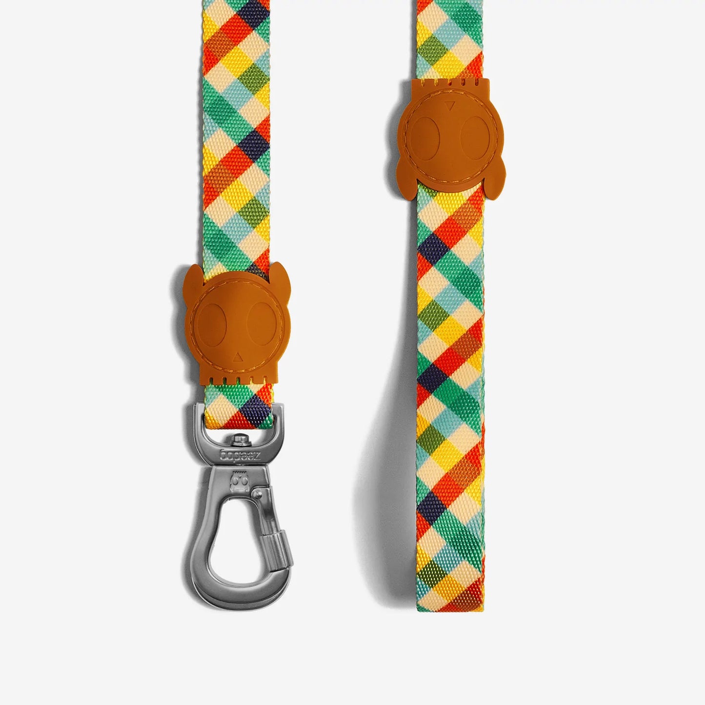 Colourful, plaid pet leash featuring a cute skull-shaped rubber handle and a sturdy metal clip. Perfect for stylish walks.