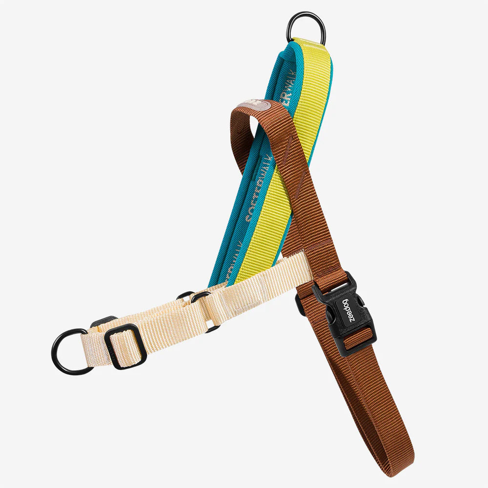 A colourful soft walker dog harness, in beige, teal, yellow and brown, feature black clips and a black branded buckle.