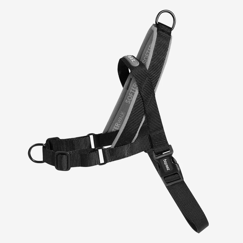 Black soft walker harness for dogs, with black clips and buckles, isolated on a white background.