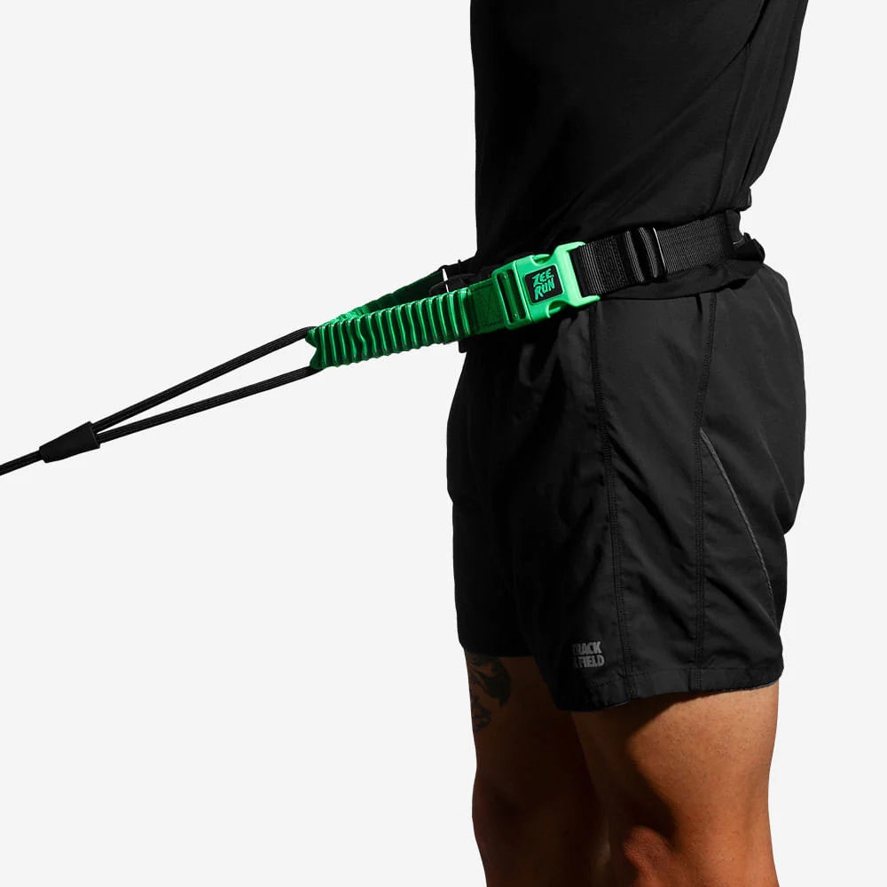 Person with a green quick-release belt and a black tether attached to shorts.