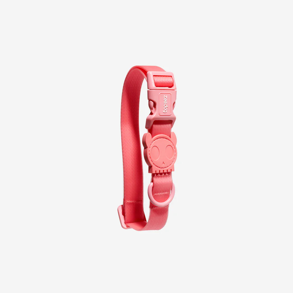 A playful pink silicone strap with a cute skull-shaped buckle, designed for a modern and fun accessory.
