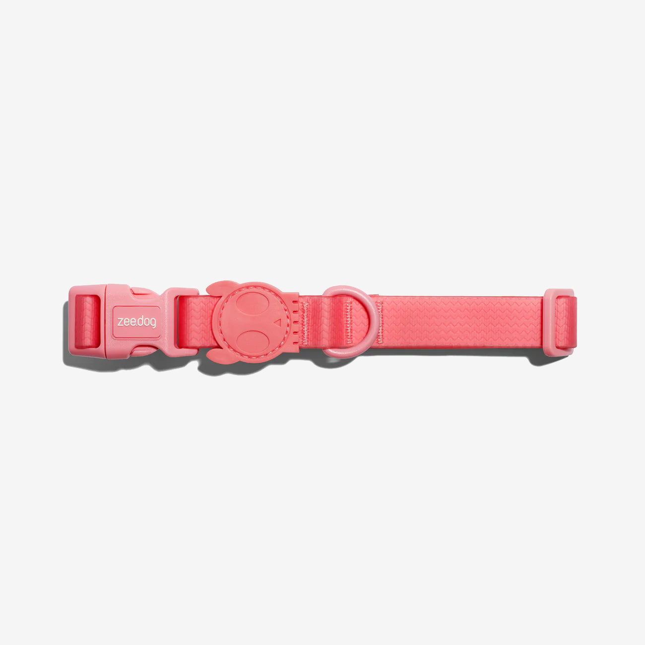 A pink dog collar with an adjustable strap and a decorative round tag, featuring the "zeedog" brand logo.
