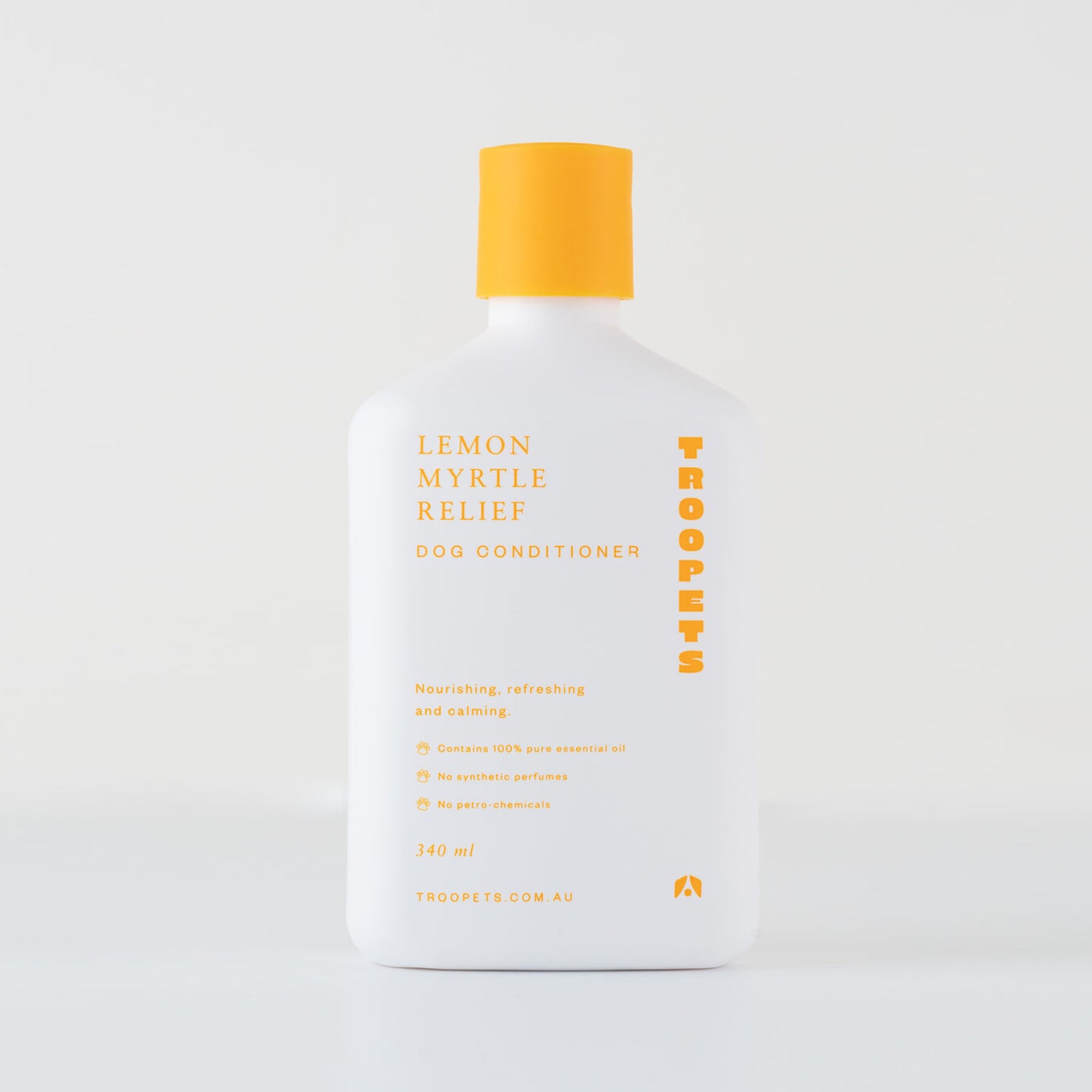A white bottle of Troopets Lemon Myrtle Relief Dog Conditioner with a yellow cap, labeled as nourishing and free from synthetic perfumes.