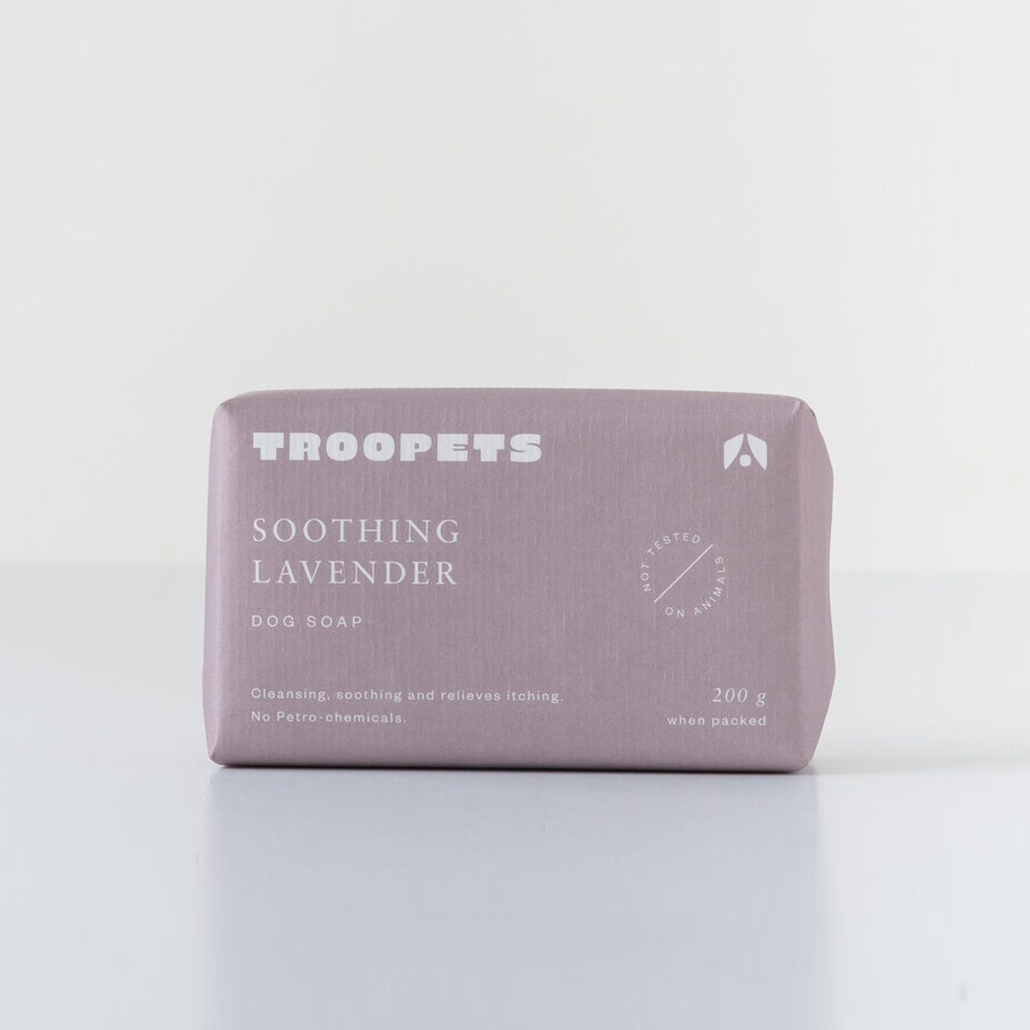Lavender dog soap bar by Troopets, packaged in a pastel purple wrapper, promotes cleansing and soothing without petro-chemicals.