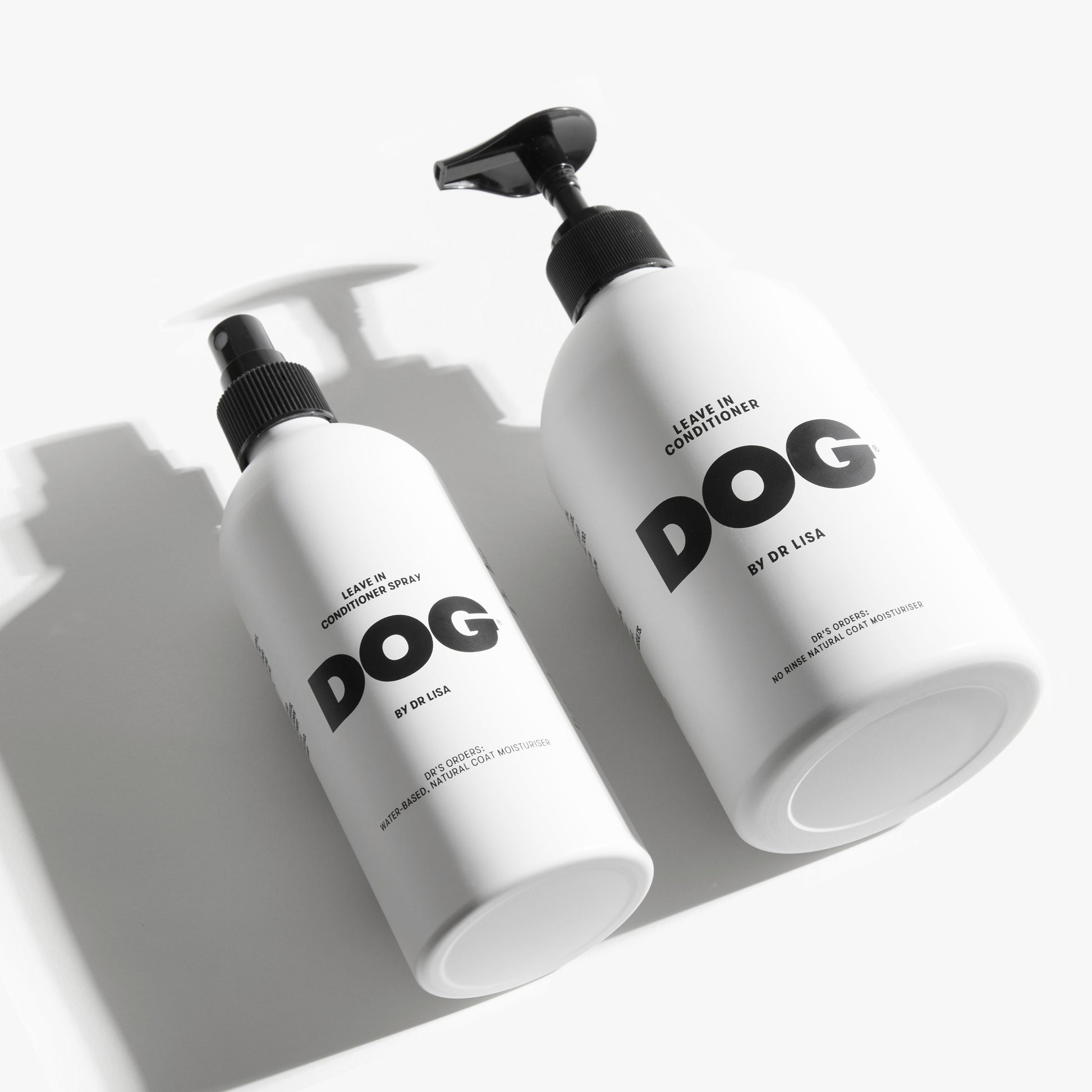 two white aluminium dog leave in conditioner bottles with black nozzle and pump