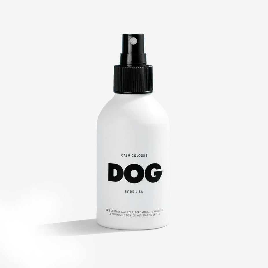 the front of a white dog cologne bottle with a black spray nozzle 