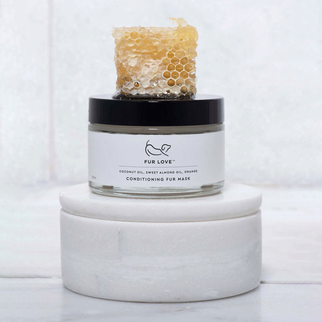 natural honeycomb sat on top of a glass jar filled with a conditioning fur mask, for dogs.