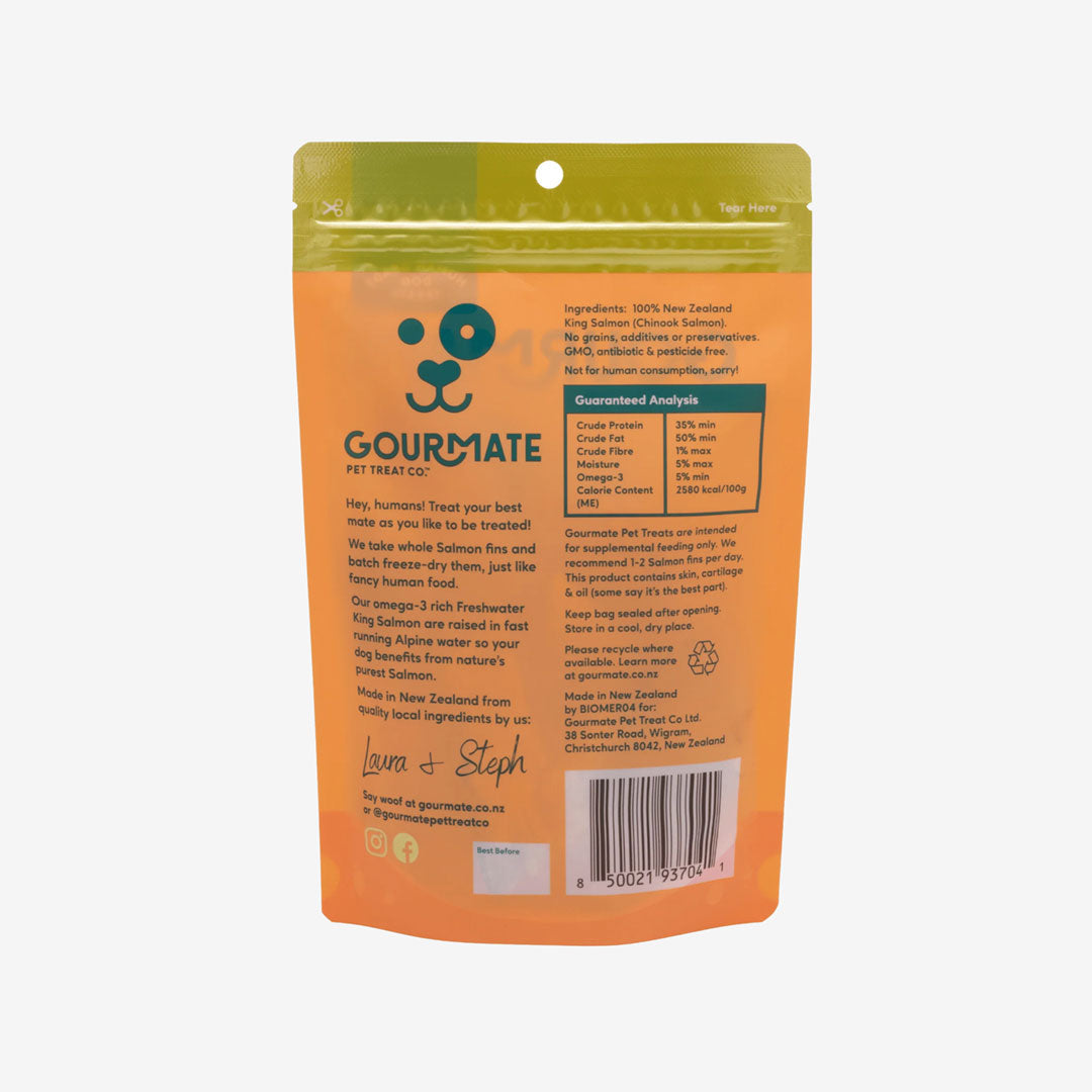 The back of an orange pouch featuring a animal face icon in green, is filled with salmon treats for dogs.