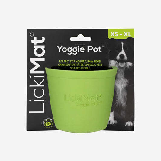 Lime green textured Licki Mat dog feeding pot, with raised bumps inside, on a plain background.