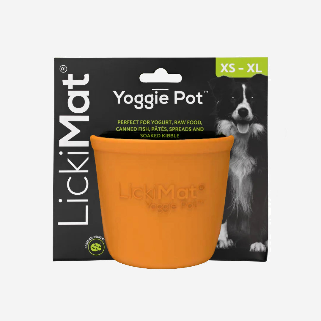 Orange textured Licki Mat dog feeding pot, with raised bumps inside, on a plain background.