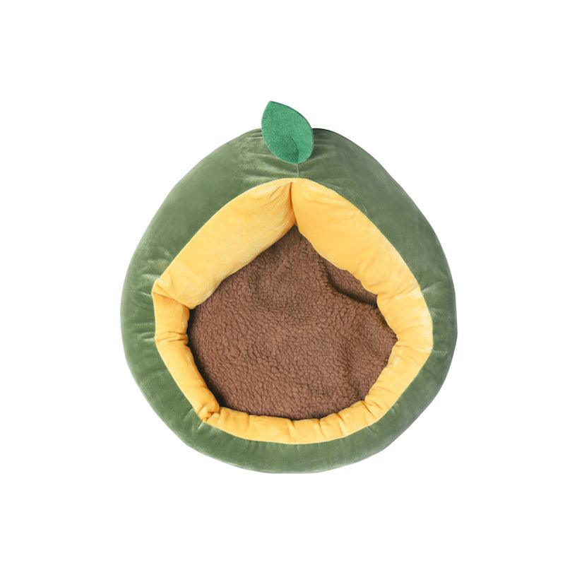 A plush avocado-shaped pet bed with a green outer layer, a brown round cushion inside, and a small green leaf on top.