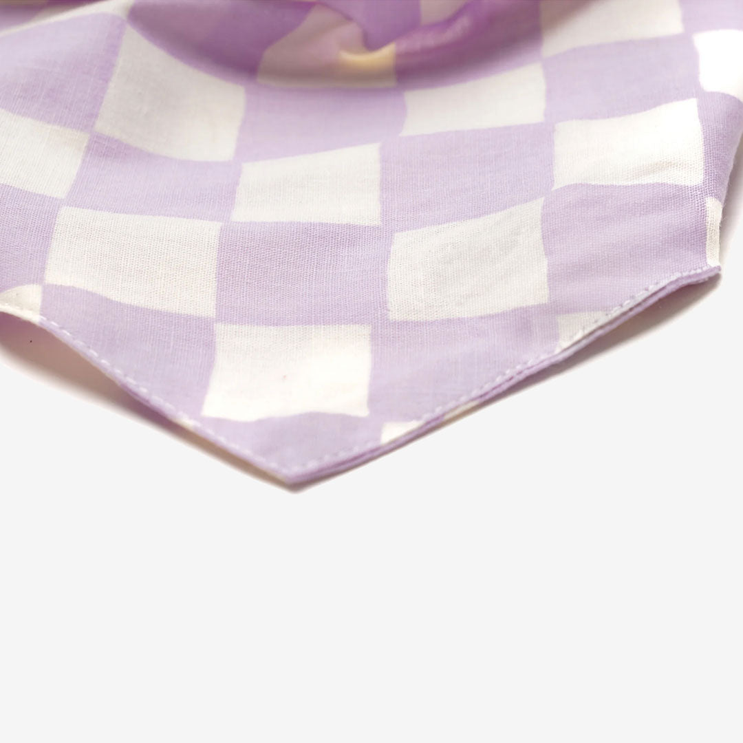 A close up of fabric of a lilac and white checkered dog bandana