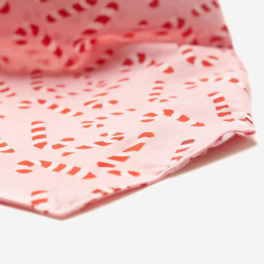 100% cotton dog bandana with a candy cane pattern on a pale pink