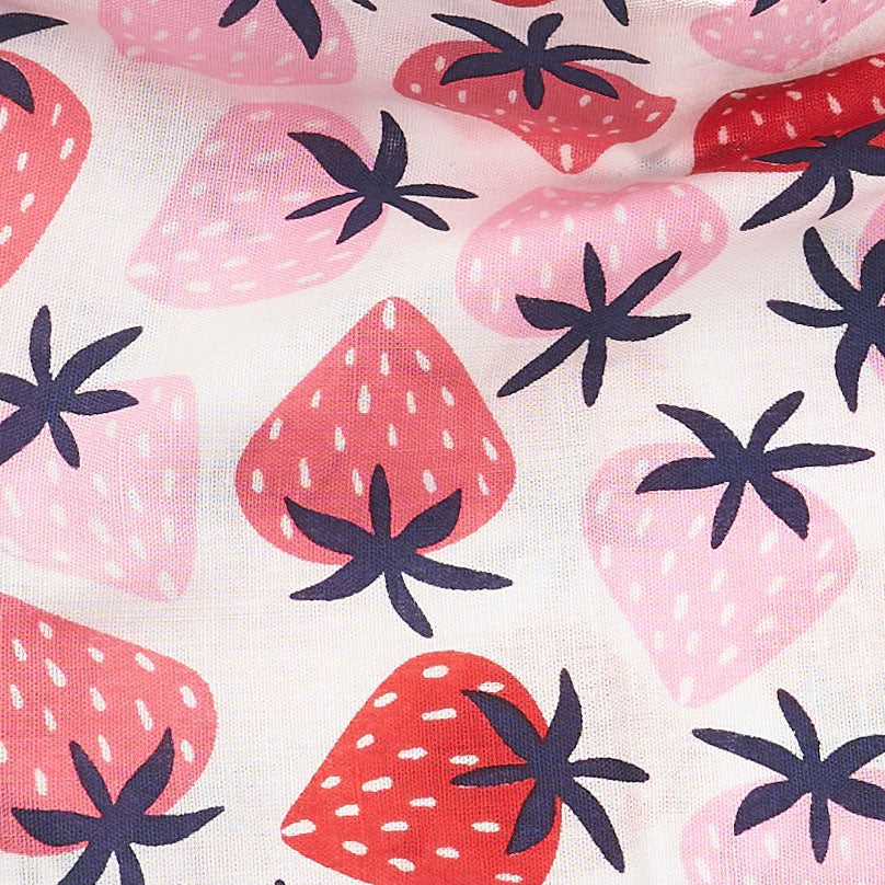 Close up fabric detail of a 100% cotton dog bandana patterned with fresh pink and red strawberries