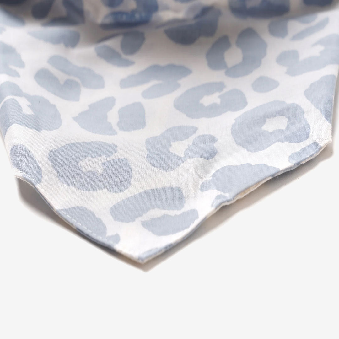 Close up fabric detail of a 100% cotton dog bandana with a pale blue cheeter print on white