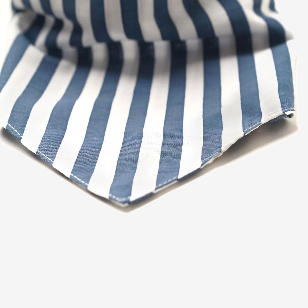 Close up fabric detail of a 100% cotton navy blue and white striped dog bandana