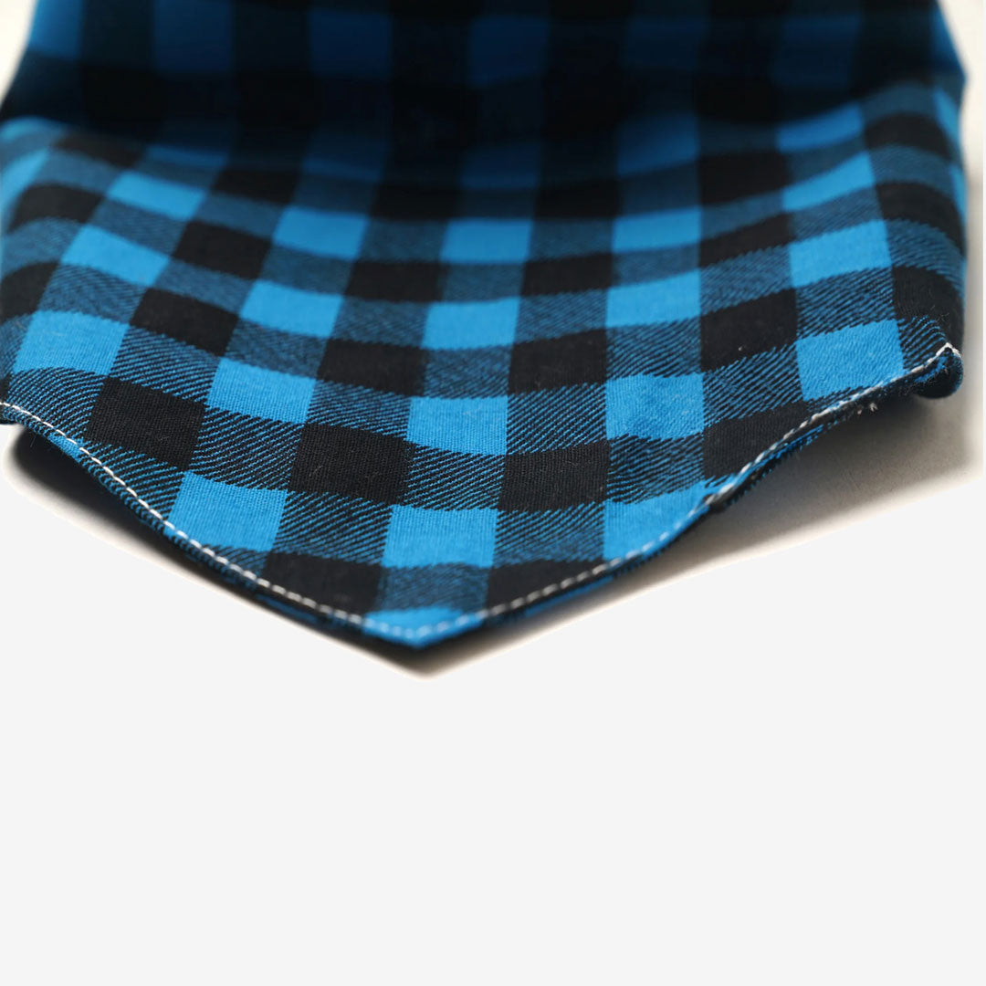 Close up of a plaid checkered dog bandana in blue and black